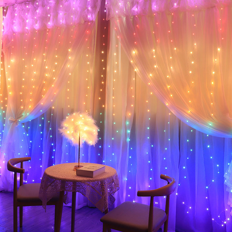 Cortina de luces LED multicolor 3x2 m encendida en una ventana